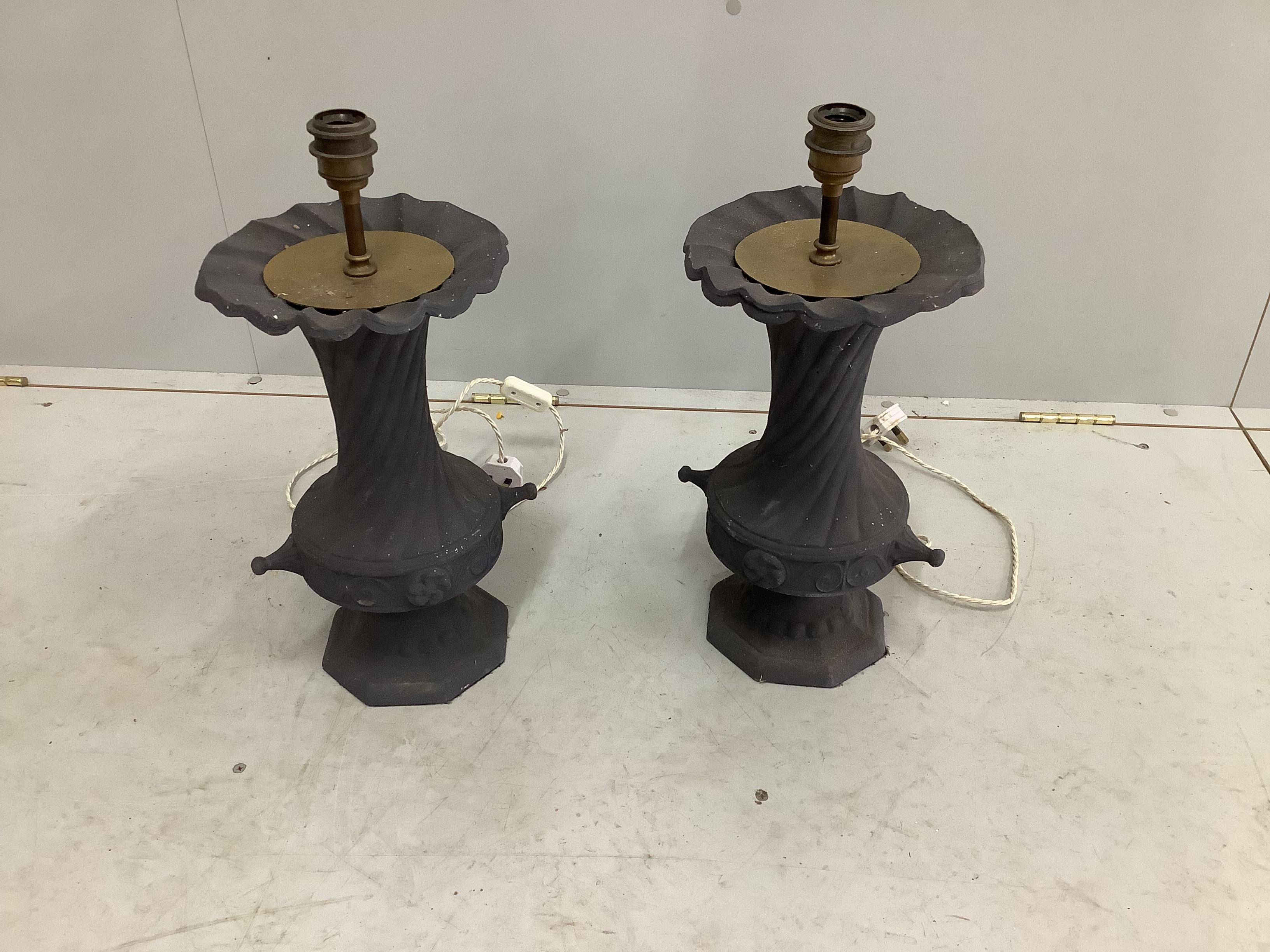 A pair of painted cast iron table lamps, adapted, height including fittings 50cm